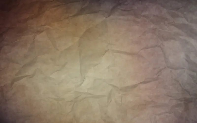 Crumpled paper lit in warm purple and amber tones
