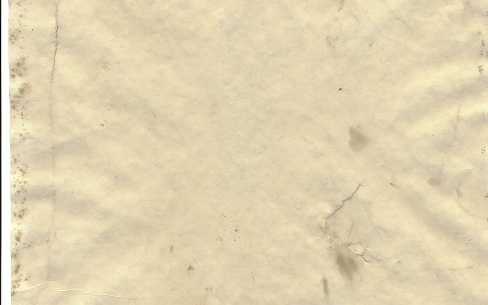 Worn, stained sheet of old paper with soft creases and frayed edges